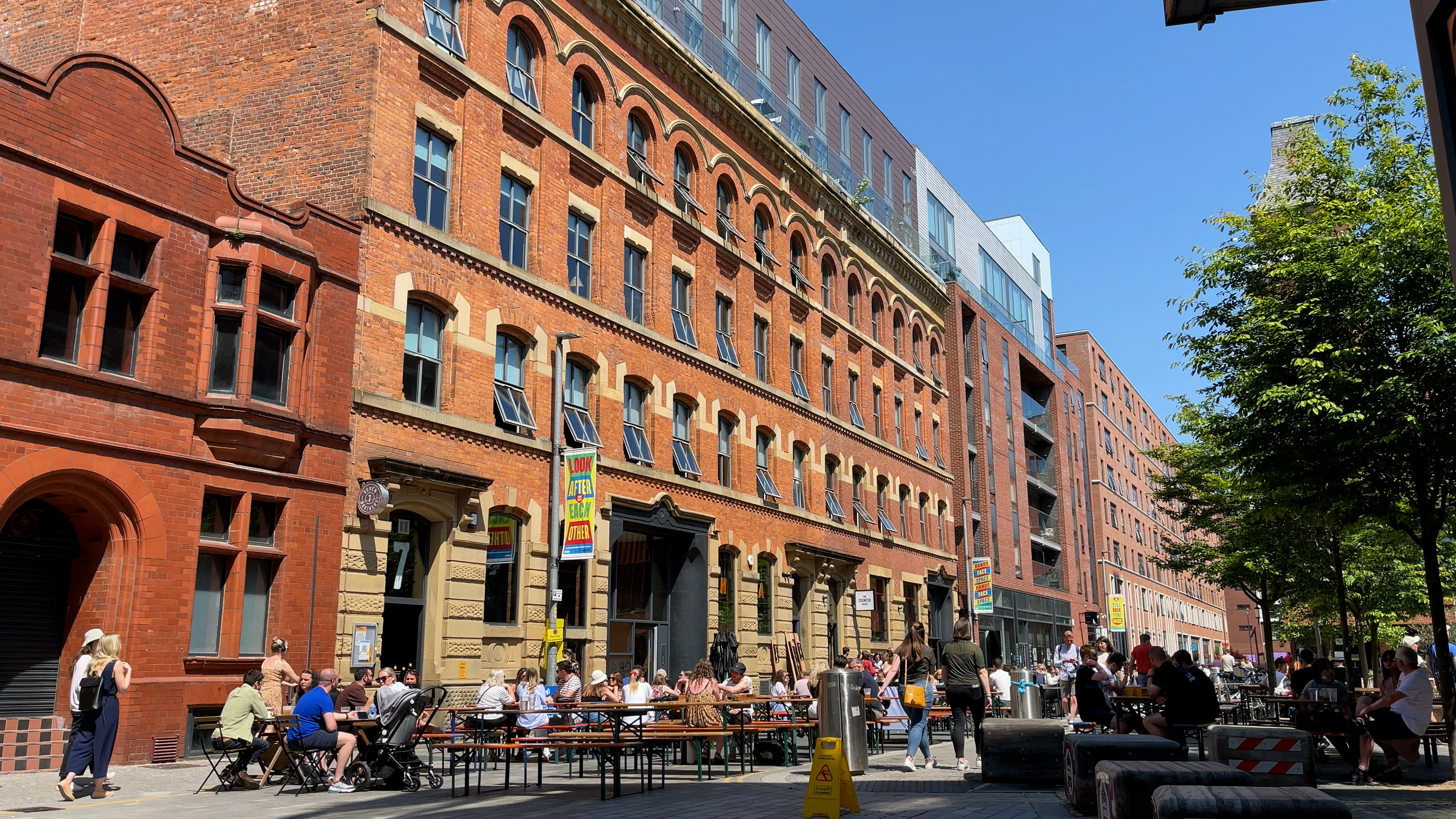 Ice Plant on Cutting Room Square with people eating and drinking outside in the sun