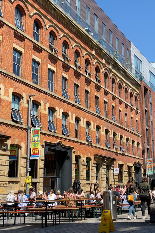 Ice Plant on Cutting Room Square with people eating and drinking outside in the sun