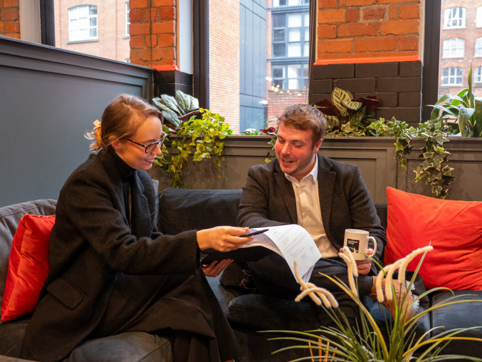 A man and woman reading a document about switching letting agent