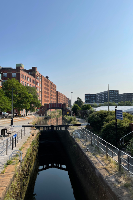 Locks and footbridge over Rochdale Canal with Ancoats mills in the background