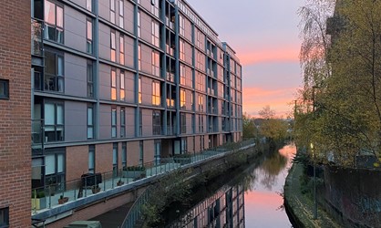 Flint Glass Wharf apartments next to Rochdale Canal at sunset